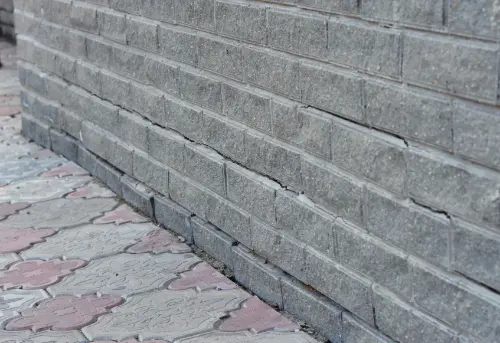 Foundation water management system diverting rainfall away from foundation walls