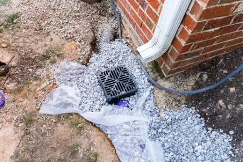 French drain installation redirecting water away from a home's foundation